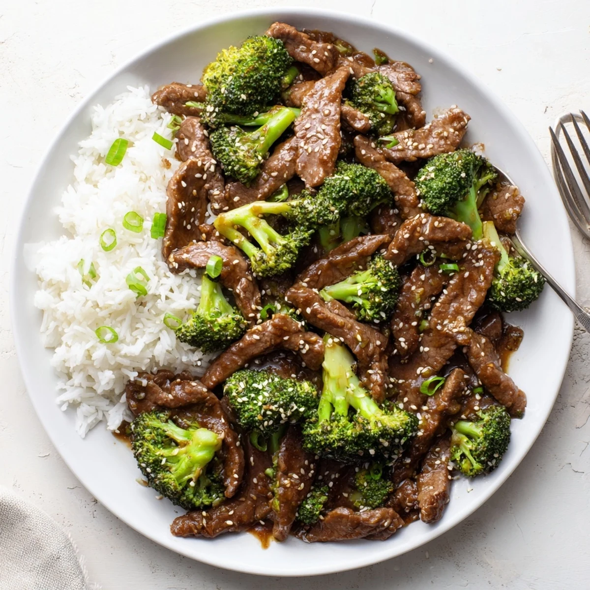 Slow cooker beef and broccoli with tender meat in savory brown garlic-soy sauce over white rice