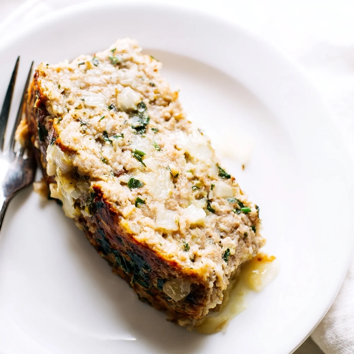 Savory garlic Parmesan chicken meatloaf ready for family dinner with roasted vegetables
