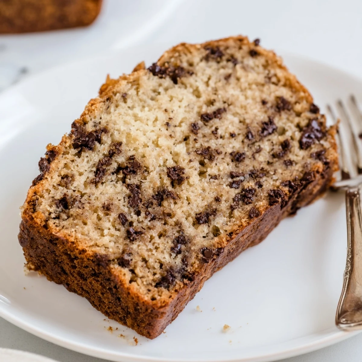 Moist homemade banana bread studded with semi-sweet chocolate chips, perfect sliced thick for breakfast or dessert