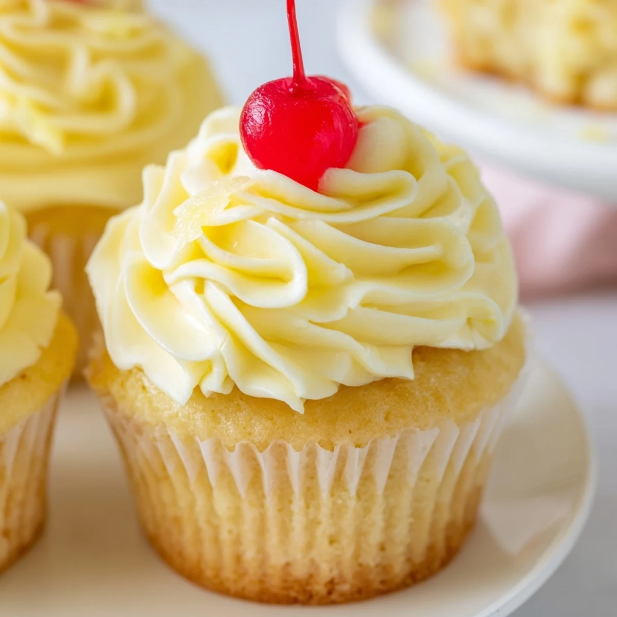 Tropical Dole Whip Cupcakes with tall piped whipped cream and a pineapple wedge