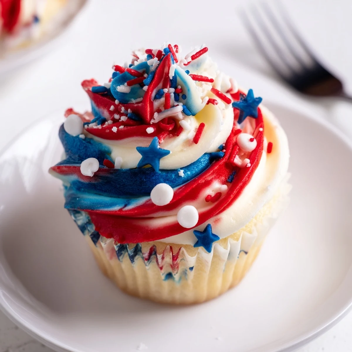 Close view of Patriotic Firework Cupcakes showing fluffy vanilla cake and shimmering toppers
