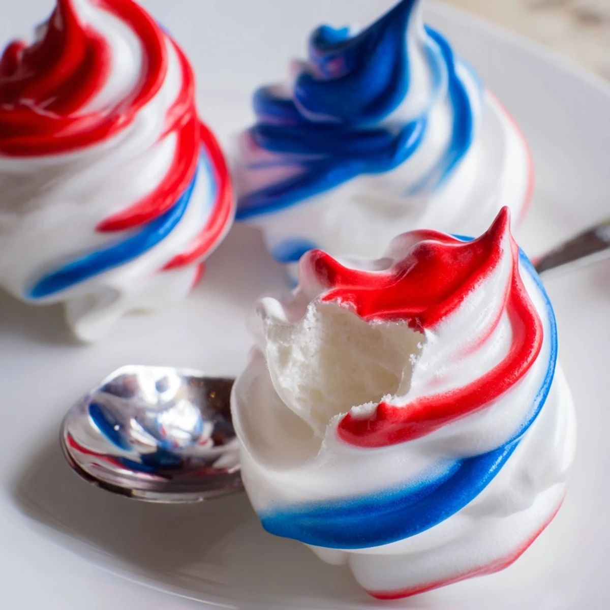 Serve Patriotic Meringue Kisses with fresh berries for Fourth of July gatherings