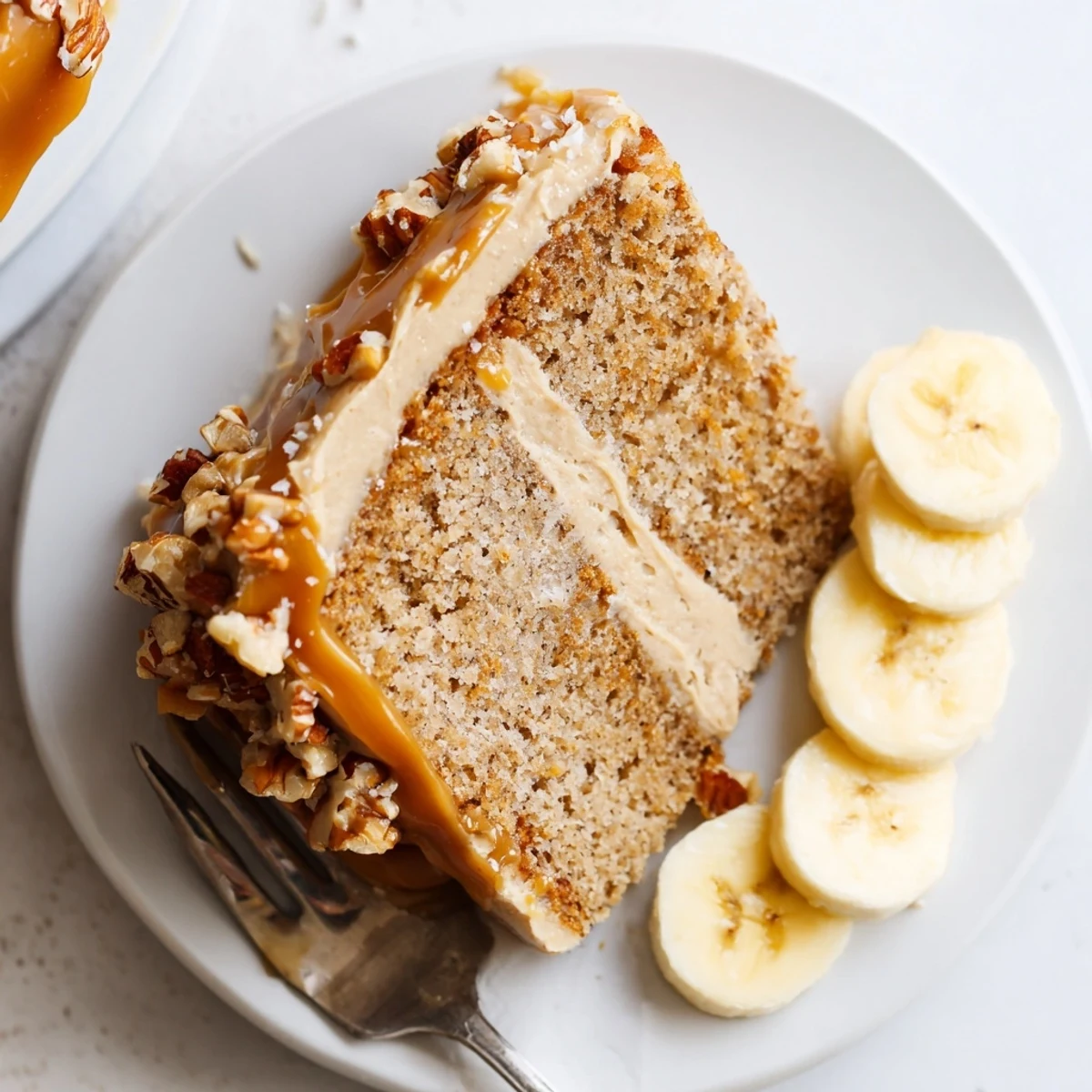 Slice of warm Salted Caramel Brown Butter Banana Cake Recipe on plate  
