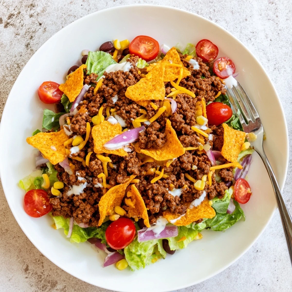 Simple Doritos Taco Salad tossed with ranch, crunchy chips, seasoned beef