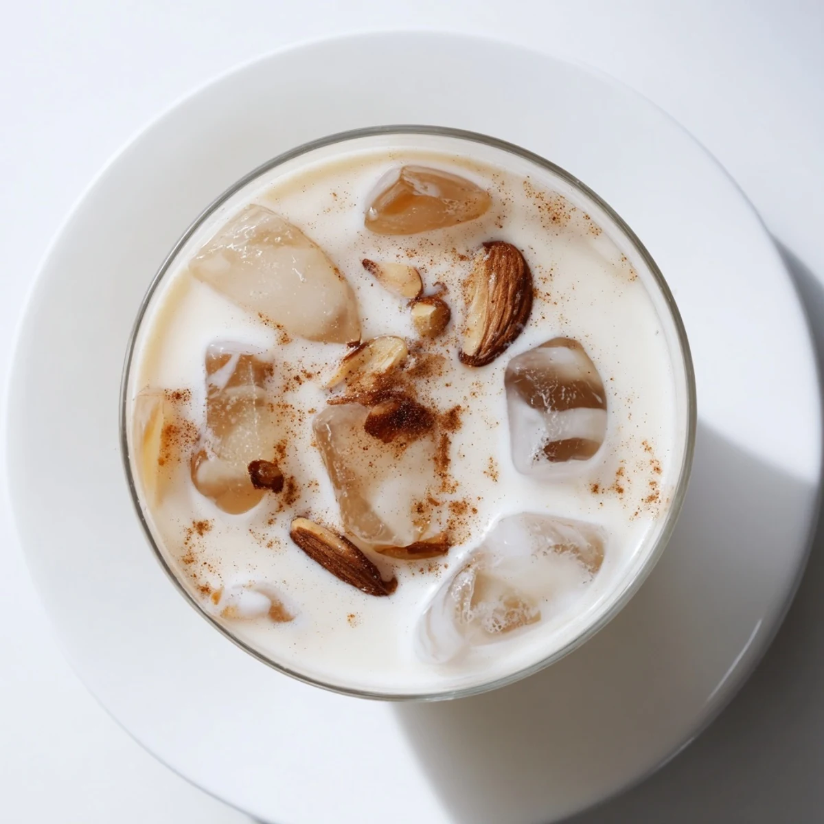 Creamy refreshing summer roasted almond milk drink served over ice in clear glass