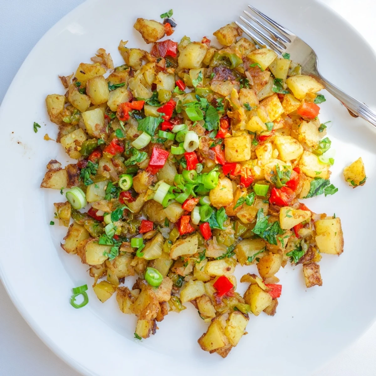 Rustic breakfast spread featuring Green Chile Hash With Crispy Potatoes accompanied by warm flour tortillas and zesty hot sauce on the side