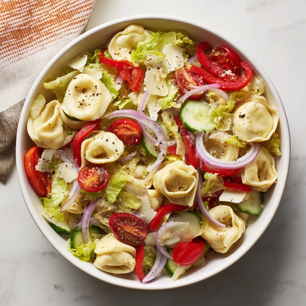 Colorful bowl of fresh grinder tortellini salad recipe with cheese tortellini, crisp vegetables, and zesty dressing