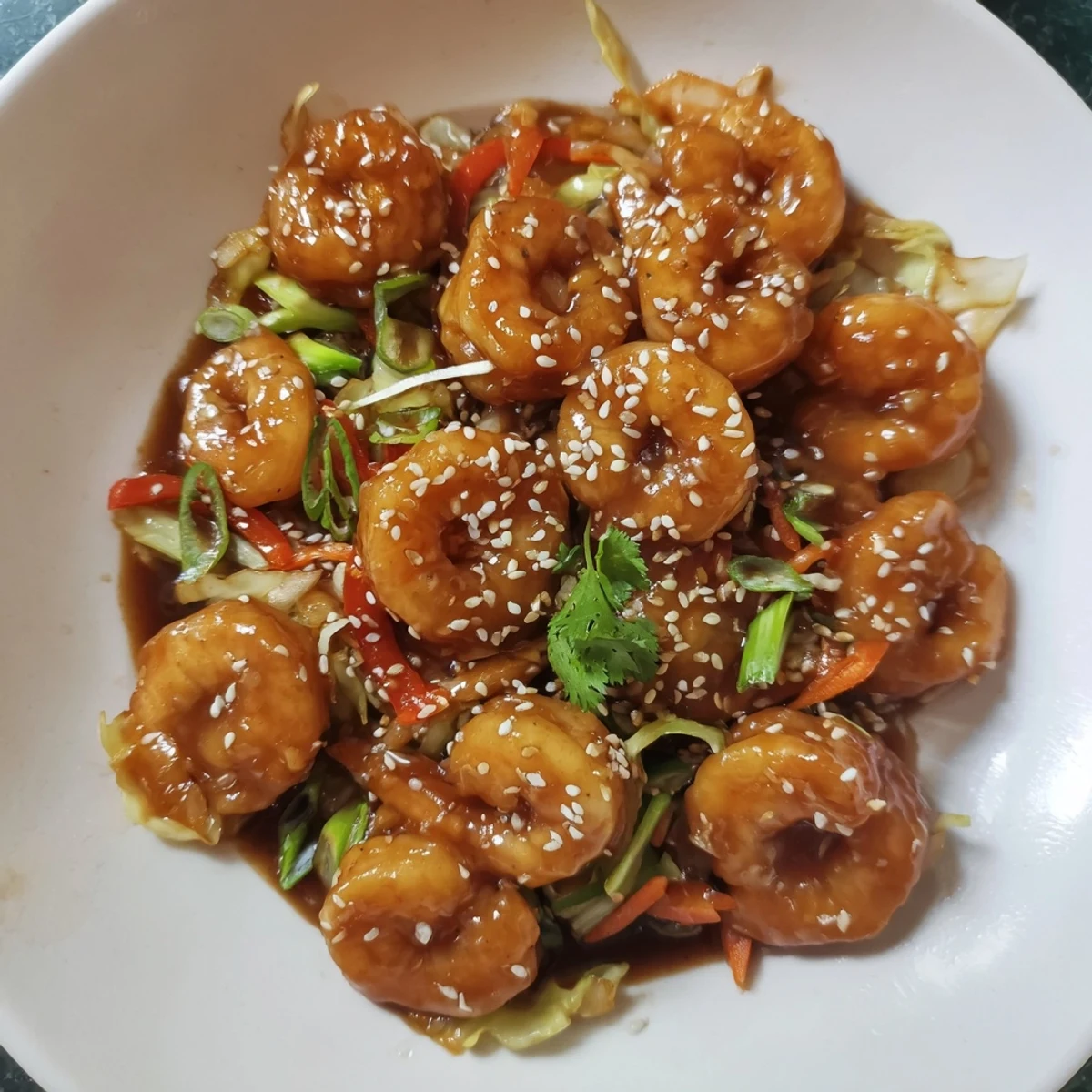 Delicious Asian Shrimp And Cabbage Stir Fry steaming over rice, glossy sesame glaze