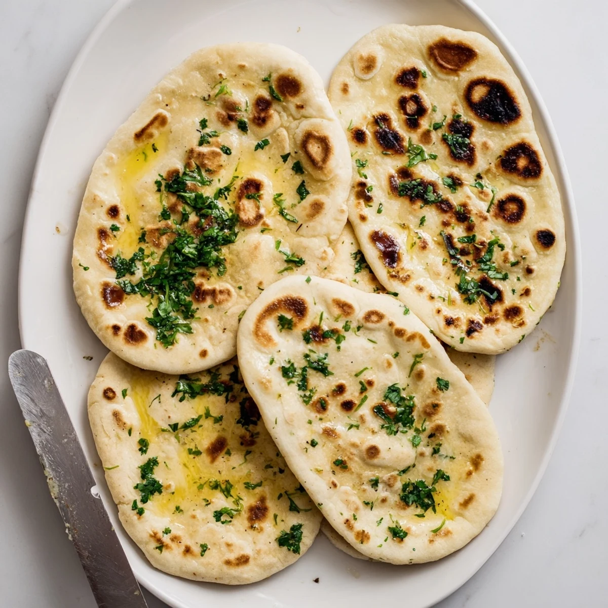 Pillowy soft Indian flatbread made with sourdough discard, perfectly blistered from the skillet