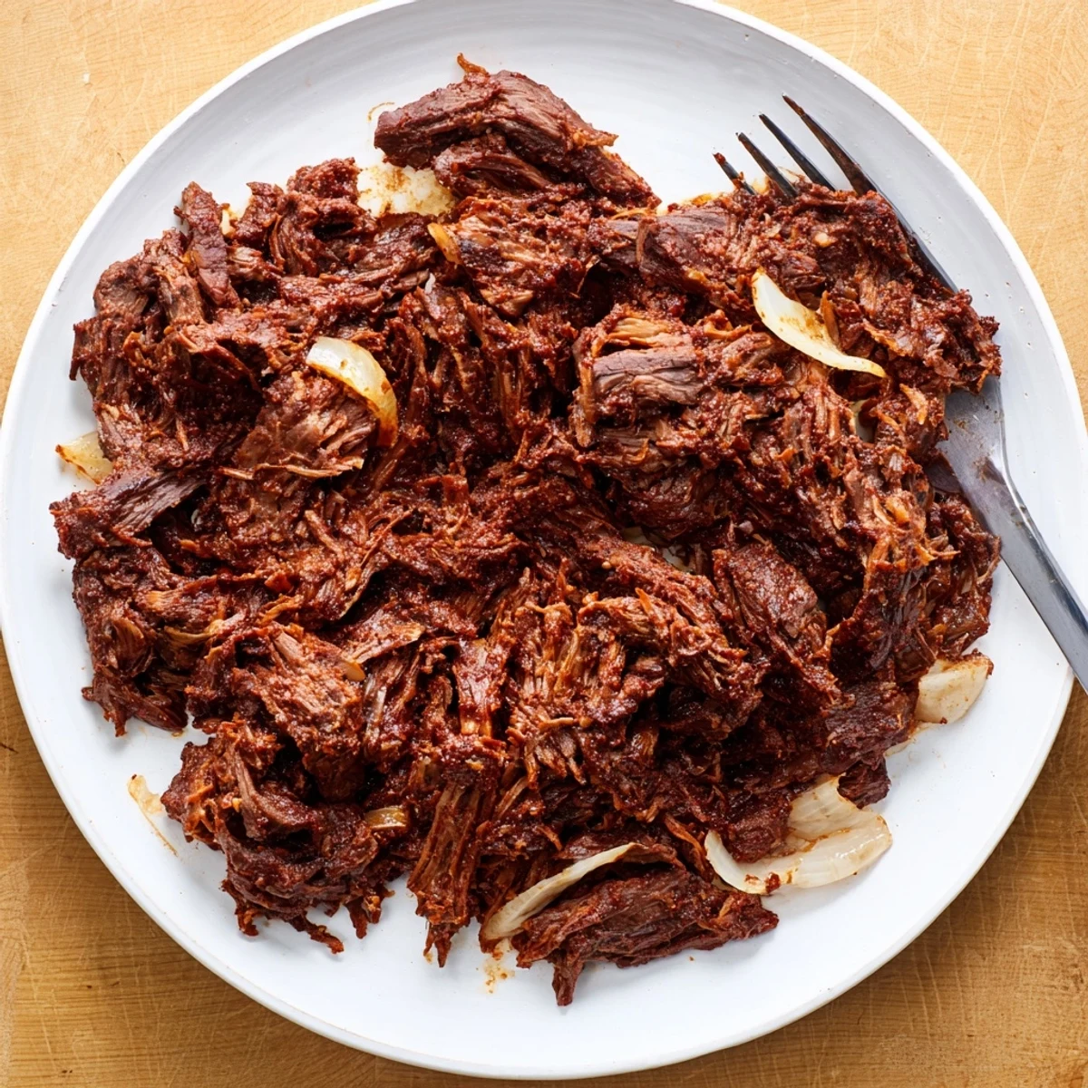 Savory slow cooker beef barbacoa filling soft corn tortillas with diced onions and cotija cheese for authentic street tacos