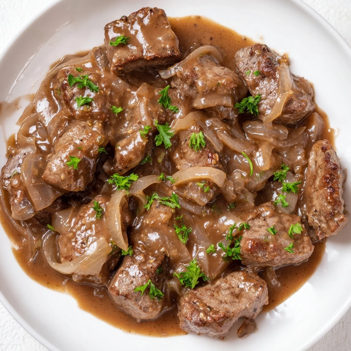 Southern style cube steak simmered in creamy beef gravy with caramelized onion slices