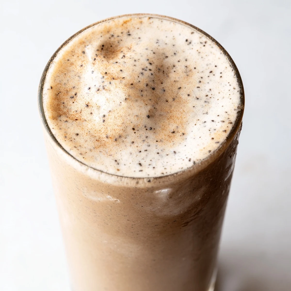 Rich banana protein coffee smoothie blended smooth and served in a mason jar